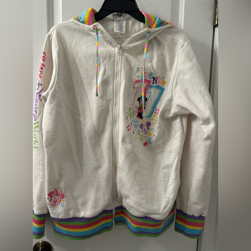 DisneyWorld 2011colorful zip up hooded jacket. Designs of characters are sewn on